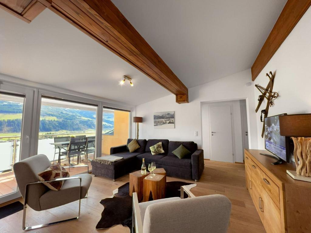 a living room with a couch and a table at Premium apartment in Piesendorf near ski area in Piesendorf