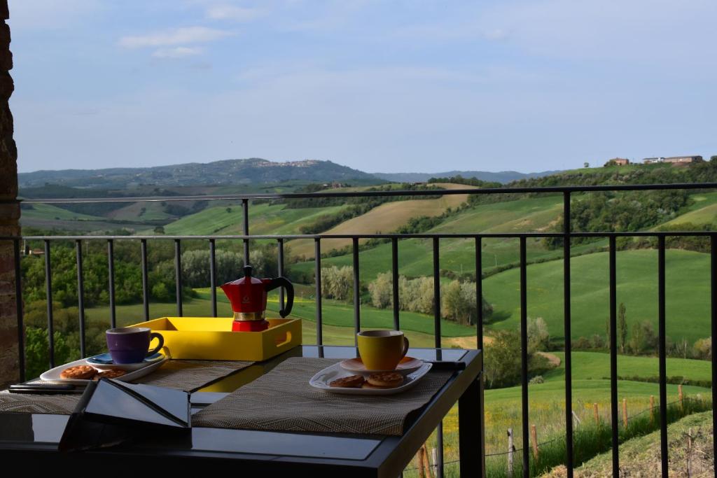 a table with two cups of coffee on a balcony at Podere La Villa in Vergelle