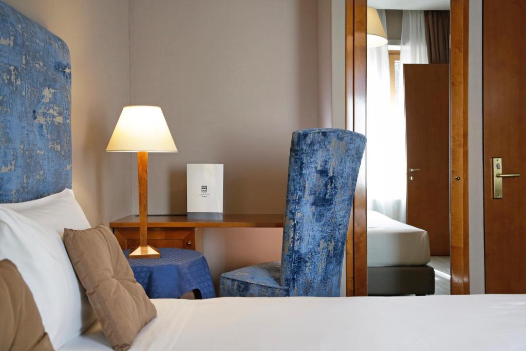 Postel nebo postele na pokoji v ubytování BeYou Hotel Ponte Milvio