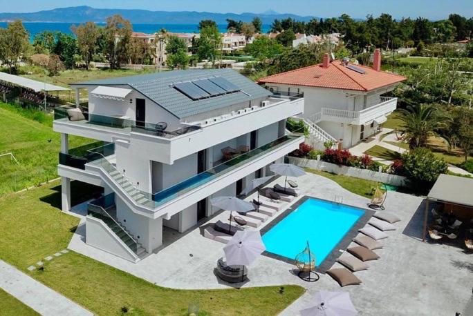an aerial view of a house with a swimming pool at V luxury Suites in Pefkohori