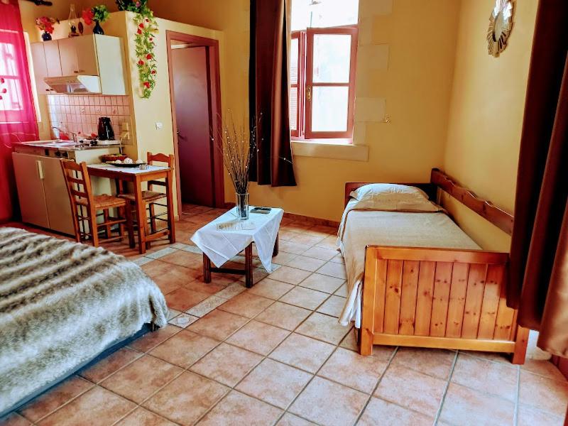 a small room with two beds and a kitchen at Caza Latina in Chania