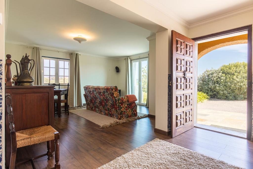 an open living room with a door leading to a dining room at Kochab Sintra by LovelyStay in Sintra