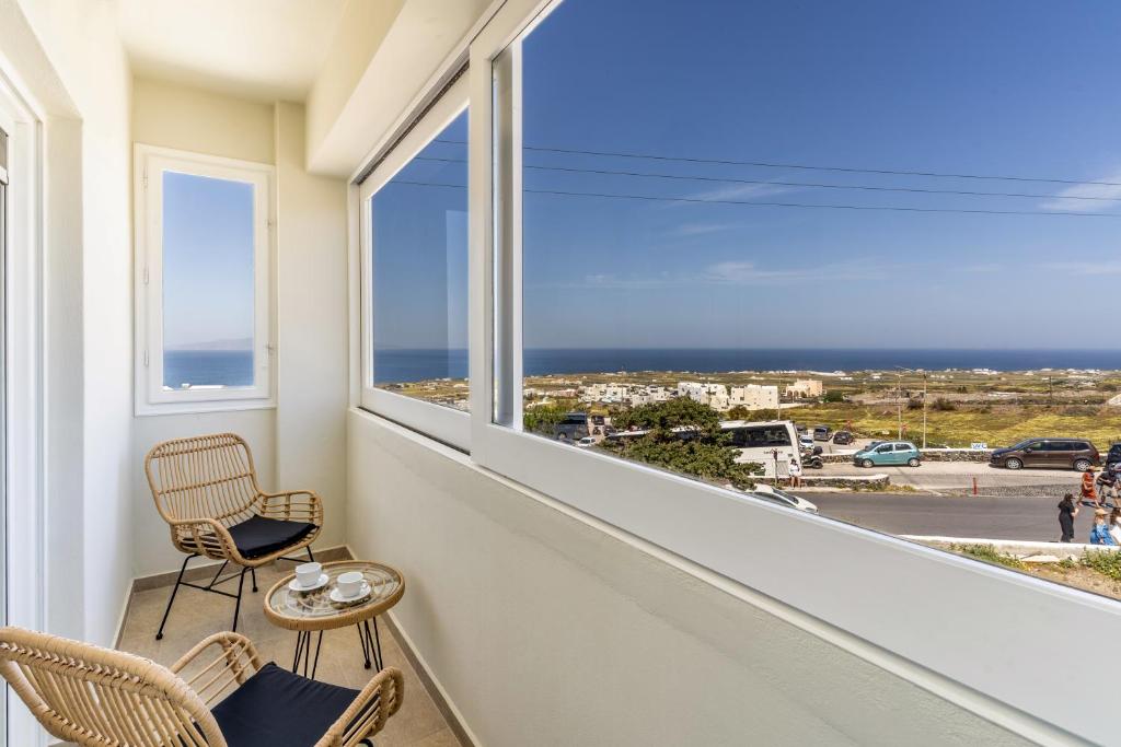 a room with a balcony with a view of the ocean at Amarie House with Sea View & Sunset View in Oia