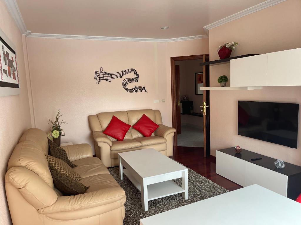 a living room with two couches and a television at Alojamiento Apostol 1 in Melide