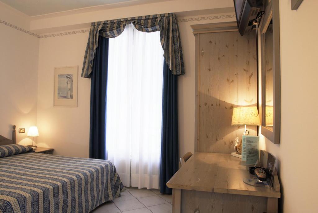 Postel nebo postele na pokoji v ubytování Hotel La Goletta