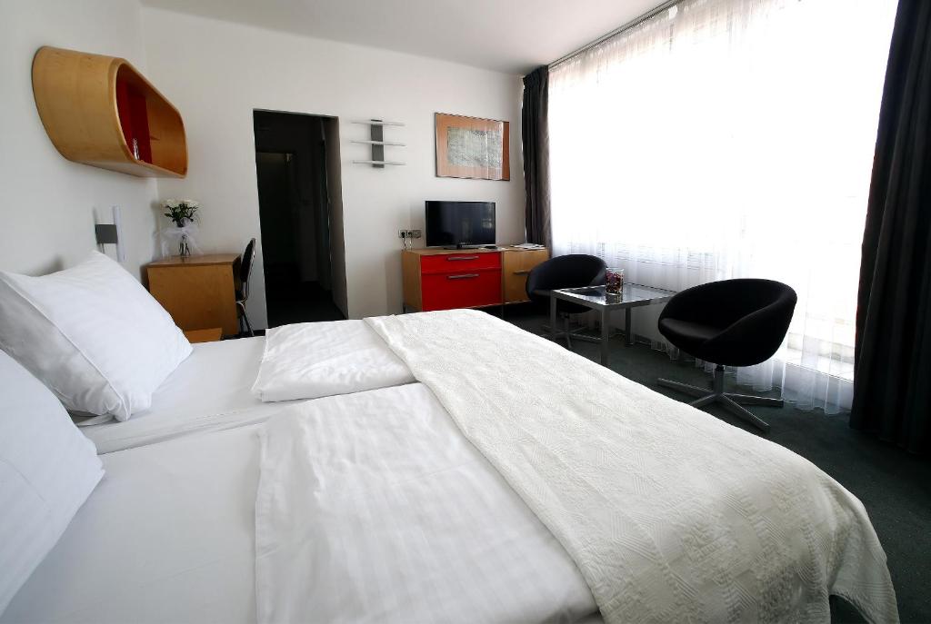 Postel nebo postele na pokoji v ubytování Hotel Central