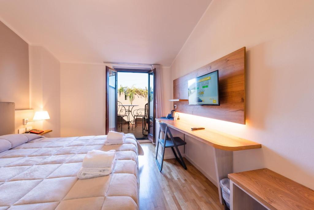 Postel nebo postele na pokoji v ubytování Hotel Palazzuolo