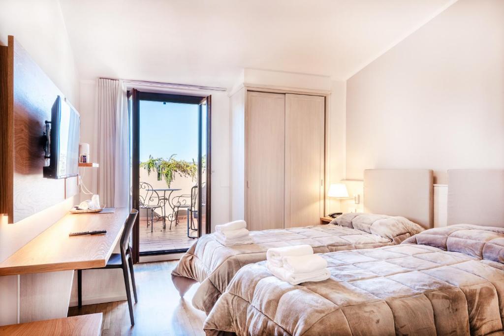 Postel nebo postele na pokoji v ubytování Hotel Palazzuolo