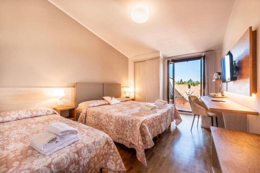 Postel nebo postele na pokoji v ubytování Hotel Palazzuolo