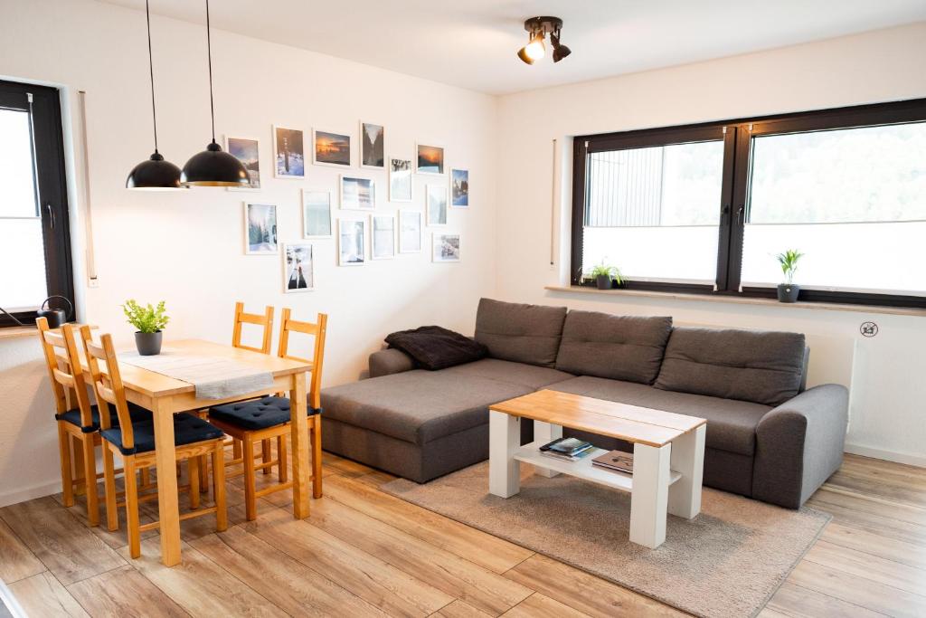 a living room with a couch and a table at Ferienwohnung am See - Sport und Erholung - WLAN in Winterberg