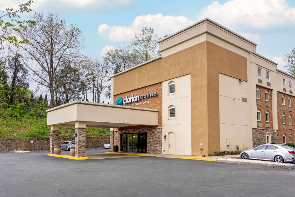 a building with a parking lot in front of it at Clarion Pointe Charlottesville in Charlottesville