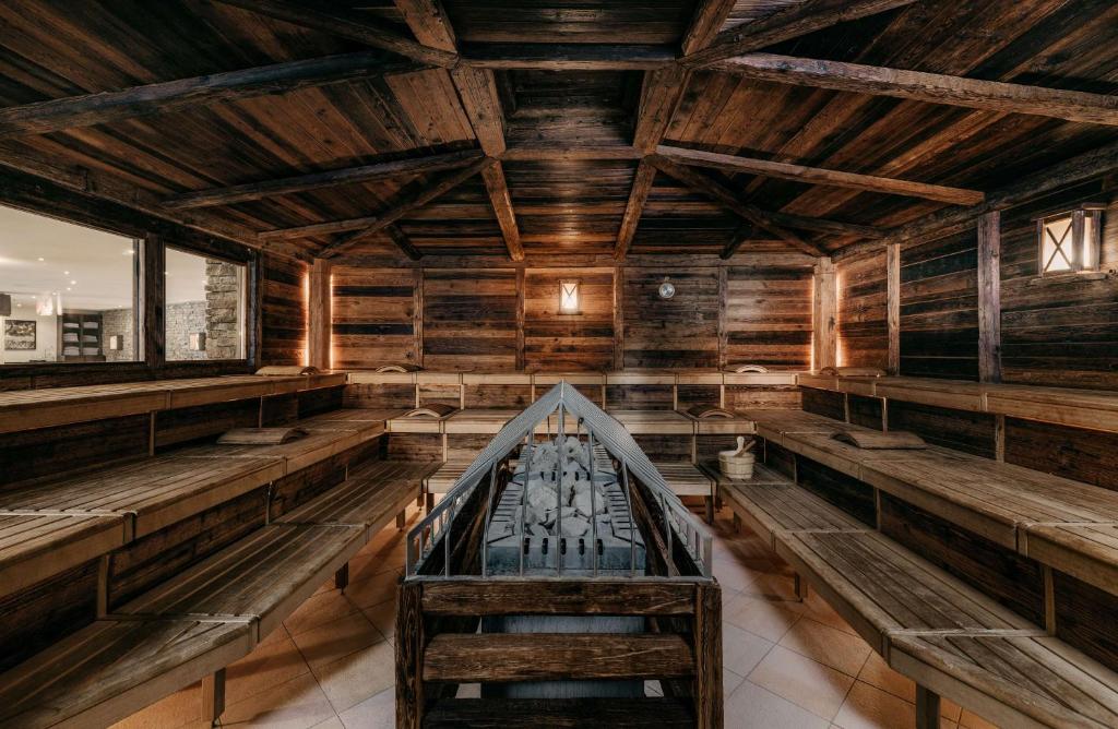 an empty church with wooden walls and benches at Grand Tirolia Kitzbühel - Member of Hommage Luxury Hotels Collection in Kitzbühel