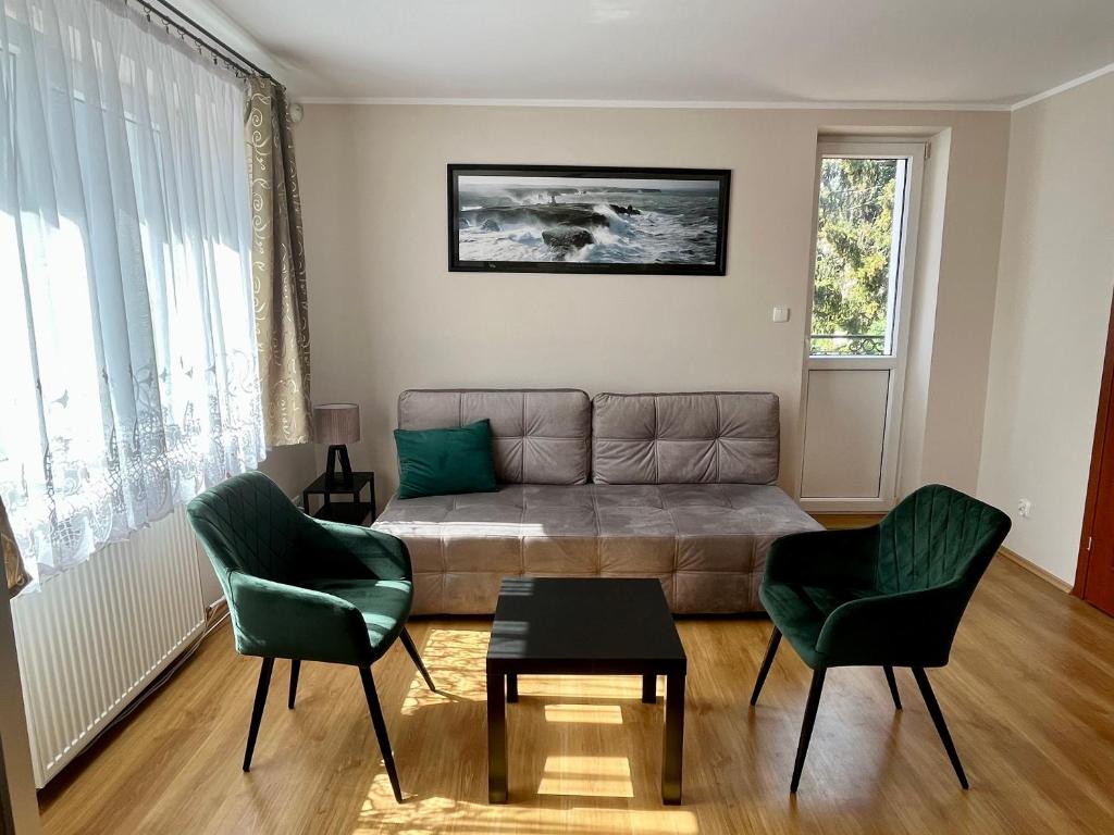 a living room with a couch and two chairs at Apartament Bursztyn, Willa Perla nad morzem in Gdańsk