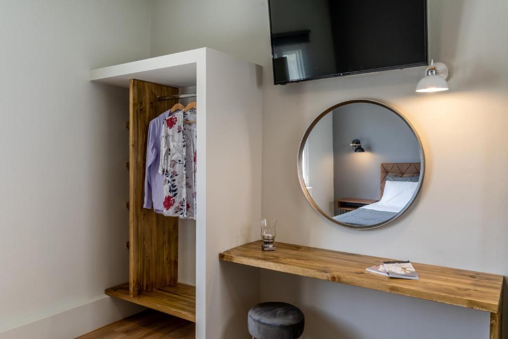 a mirror on a wall next to a room at Amarie House with Sea View & Sunset View in Oia