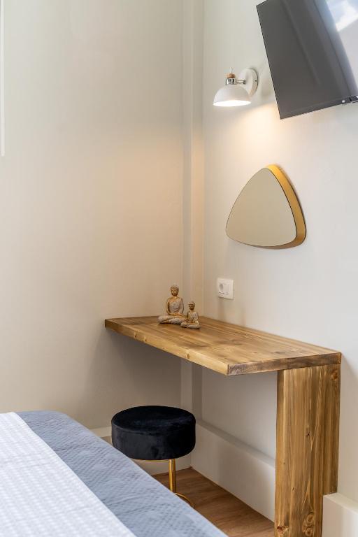 a bedroom with a desk with a lamp and a bed at Amarie House with Sea View & Sunset View in Oia