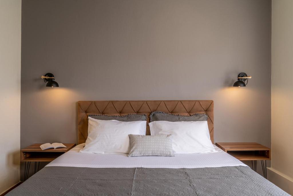 a bed with white sheets and two pillows at Amarie House with Sea View & Sunset View in Oia
