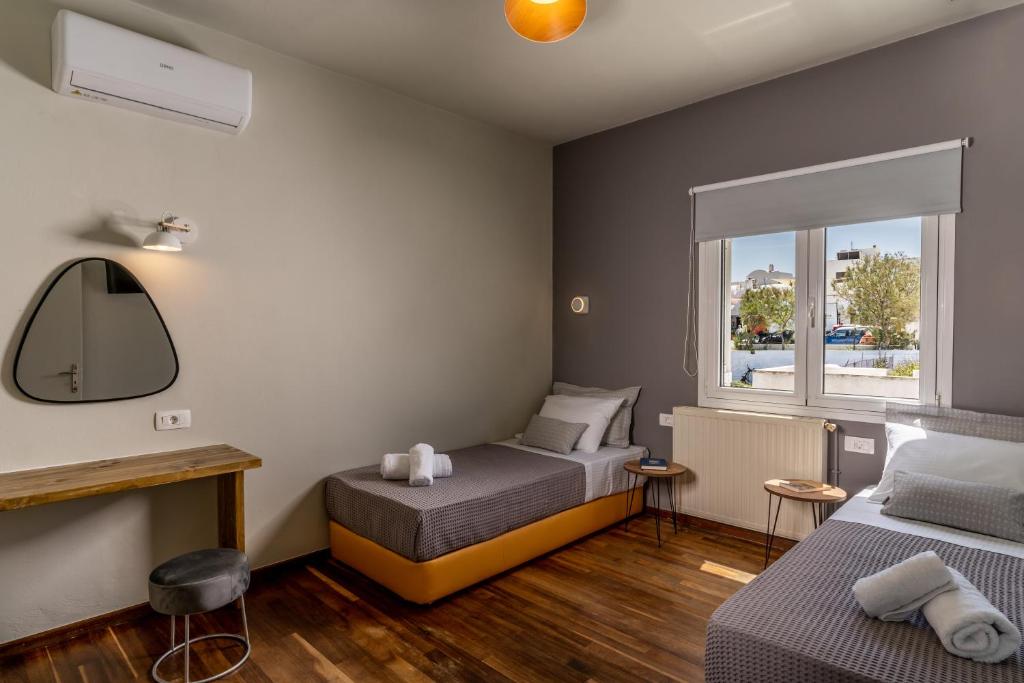 a bedroom with two beds and a window at Amarie House with Sea View & Sunset View in Oia