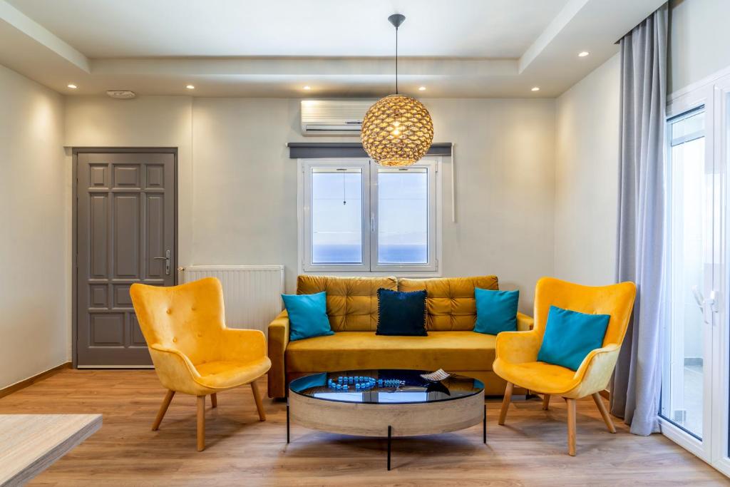 a living room with a couch and two chairs at Amarie House with Sea View & Sunset View in Oia