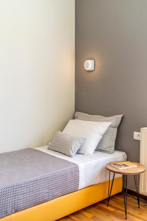 a small bedroom with a bed and a table at Amarie House with Sea View & Sunset View in Oia