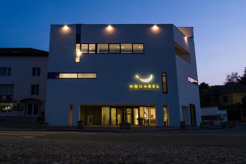 a blue building with a sign on the side of it at Hotel Boutique Aquarel in Zalău