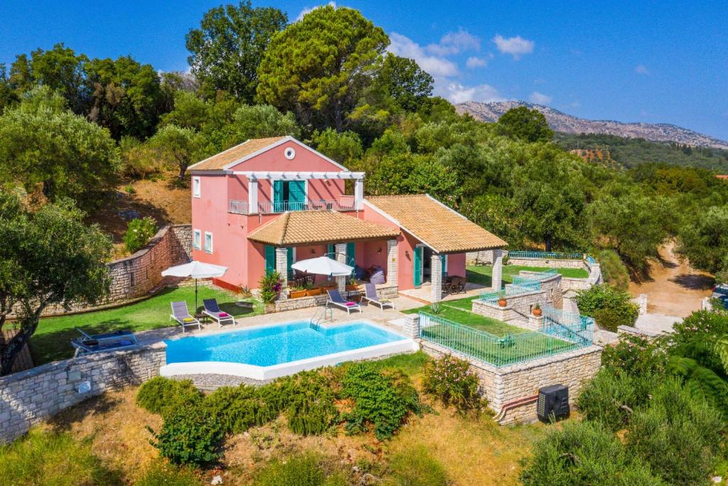 an aerial view of a house with a swimming pool at Villa Aloni Sinies in Ágios Stéfanos