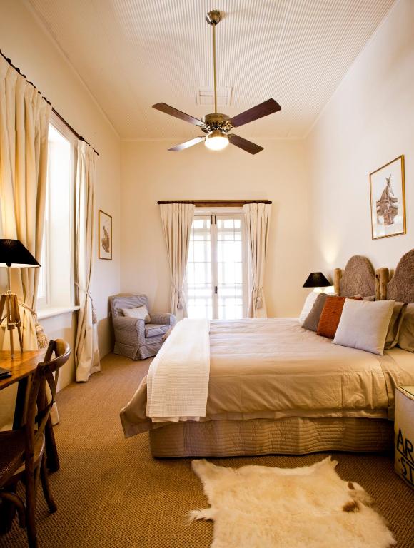 a bedroom with a bed and a ceiling fan at Arkaba Homestead in Hawker