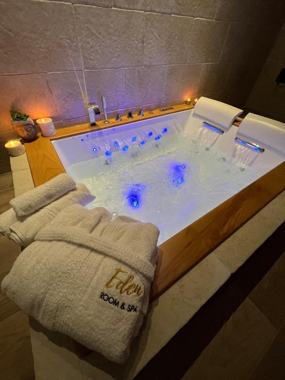 a bath tub with two towels in a bathroom at Eden Room&Spa in Torre Maggiore