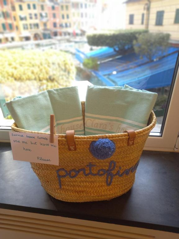 a basket sitting on a window sill with a sign at Clara's House in Portofino