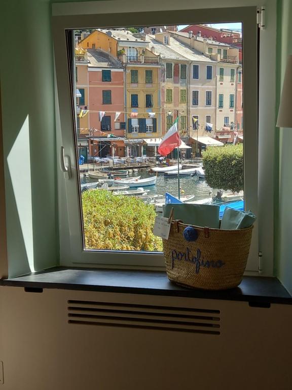 a window with a view of a harbor with boats at Clara's House in Portofino