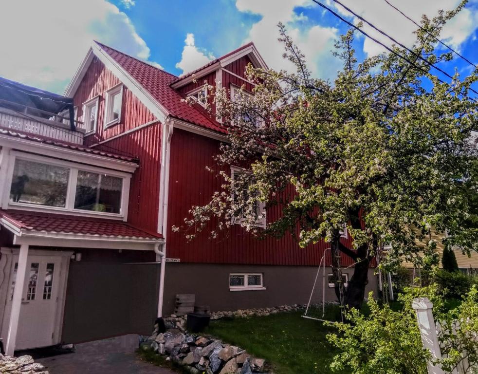 uma casa vermelha com um telhado vermelho em 120 yrs. old log house in Kuopio city centre em Kuopio