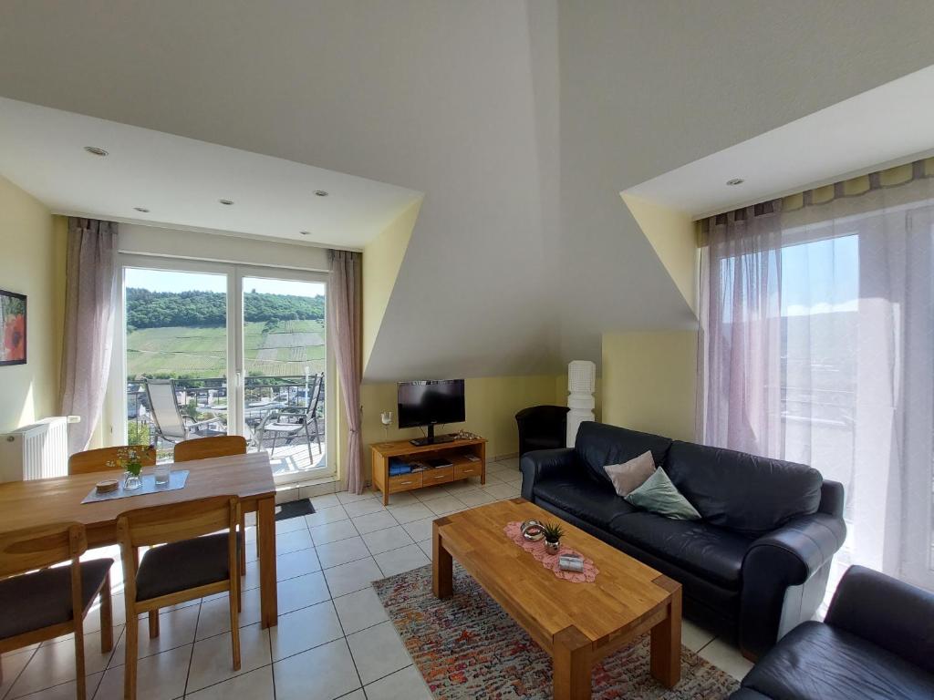 a living room with a couch and a table at Ferienwohnung Panoramablick in Lieser