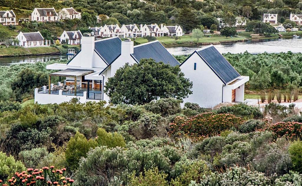 an aerial view of a white house on a hill at Oudewerfskloof Olive Farm in Stilbaai