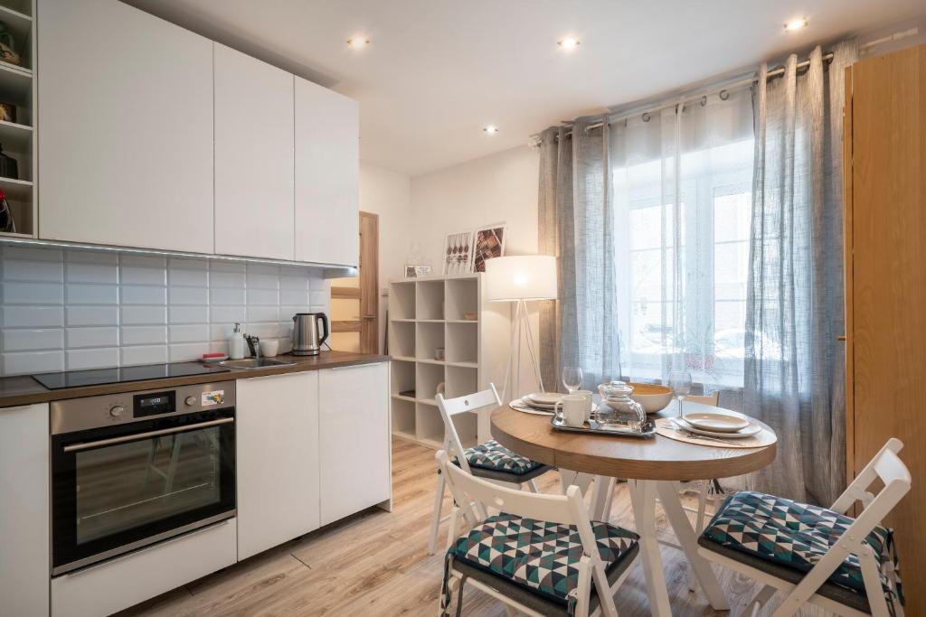 a kitchen with a table and chairs in a room at 06 Gdynia Centrum - Apartament Mieszkanie dla 4 os in Gdynia