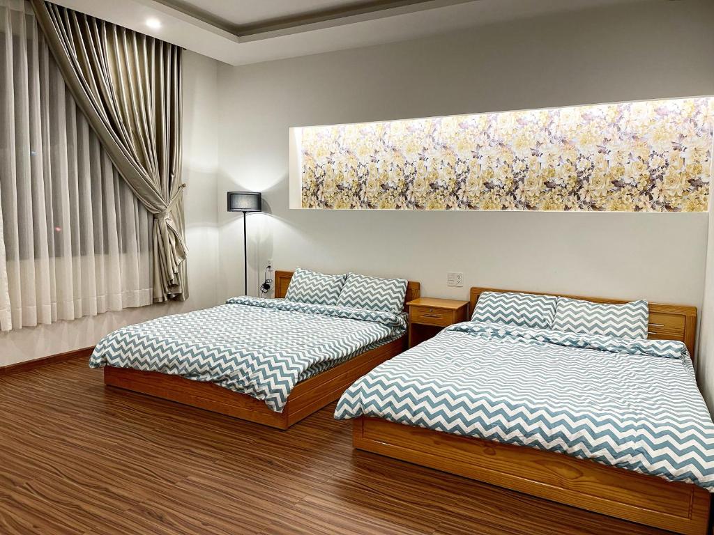 Postel nebo postele na pokoji v ubytování Tuan Long Da Lat Hostel