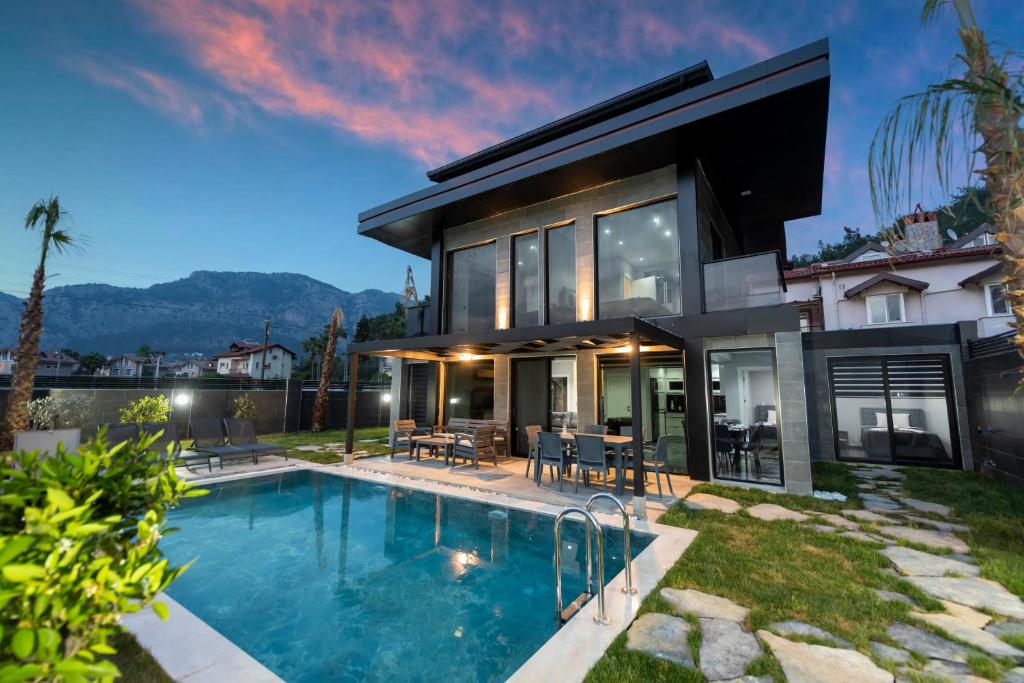 a house with a swimming pool in the backyard at Diamond Port Gocek in Göcek