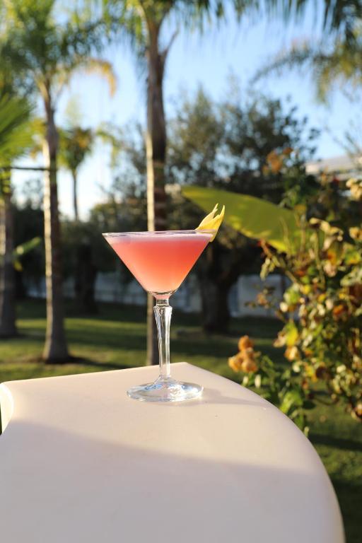 a drink in a glass sitting on top of a table at Hotel Villa Pascucci in Durrës