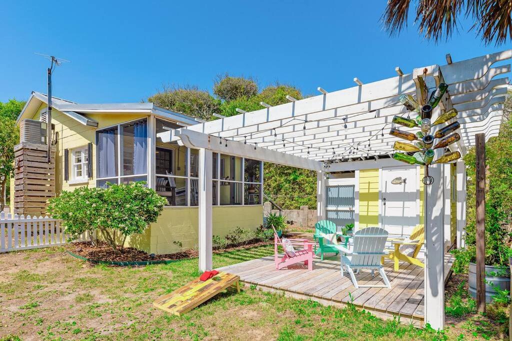 a house with a wooden deck with a pergola at 817 E Ashely Ave Pleasant Breeze in Folly Beach
