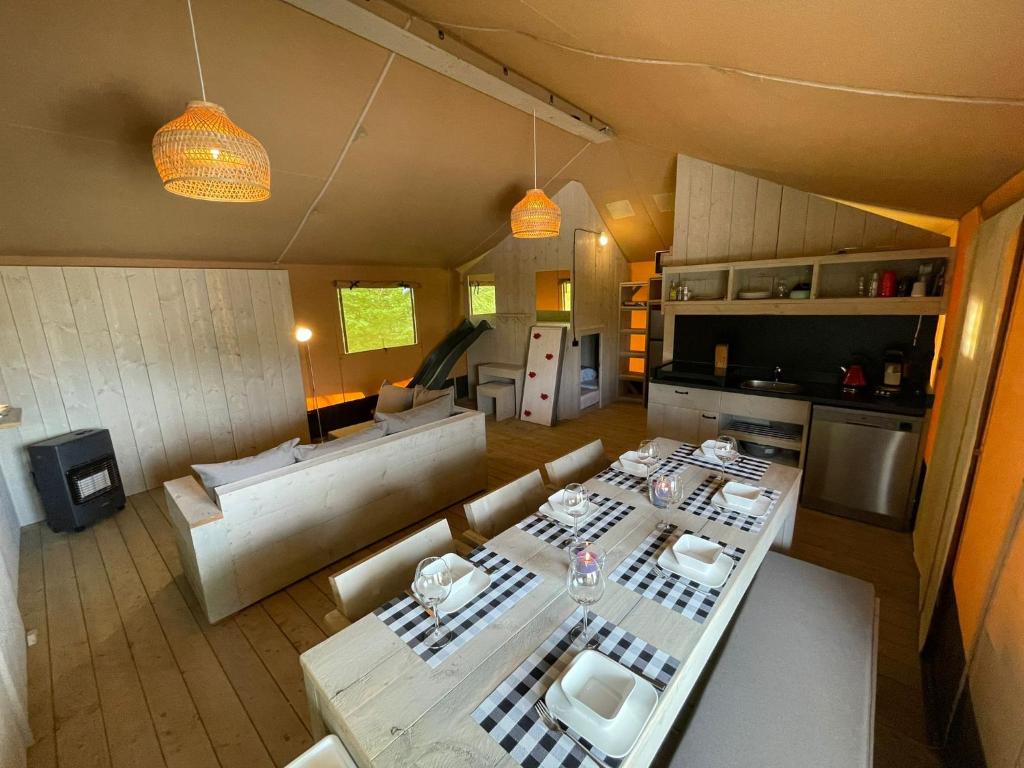 a living room with a table and a couch at Lodge Friesland in Grou