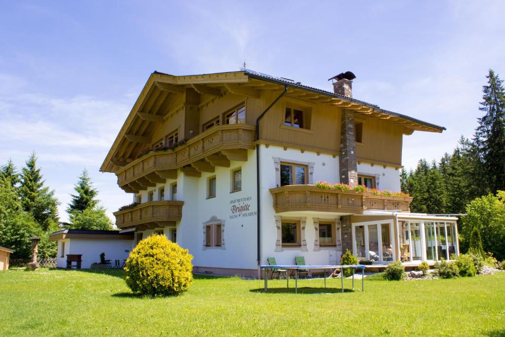 a house with a balcony on top of it at Apartmenthaus Brigitte in Leutasch