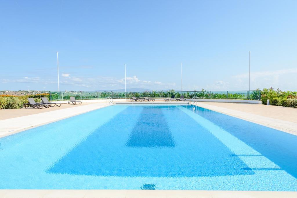 een groot zwembad met blauw water bij Boavista Golf and Spa Resort - Bayview in Lagos