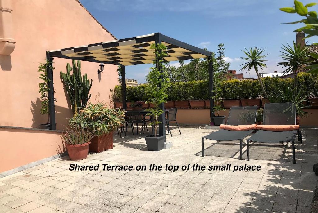 a small patio with a small table and chairs at DormiRoma - Cedro 21 Apartments in Rome