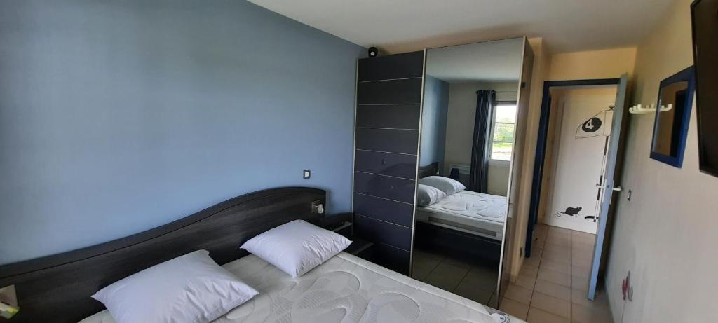 a bedroom with a large mirror and a bed at Next to Golf-club House in Talmont
