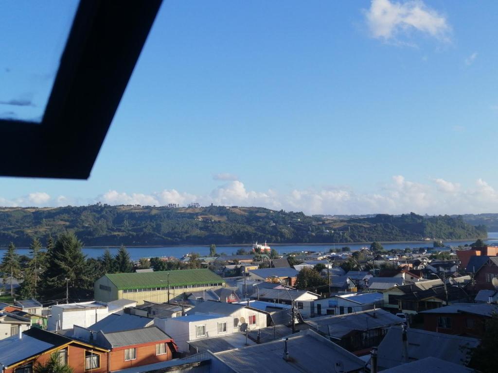 a view of a town with a river and houses at Cabaña piedra azul in Dalcahue