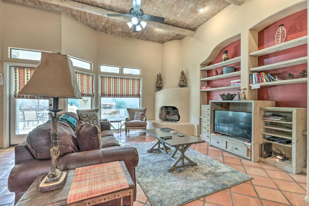 a living room with a leather couch and a television at Community Pool Pueblo Home Near Downtown Mesa in Mesa