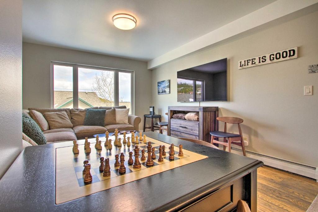a living room with a chess set on a table at Cozy Montana Condo with Walk to Big Sky Resort! in Big Sky