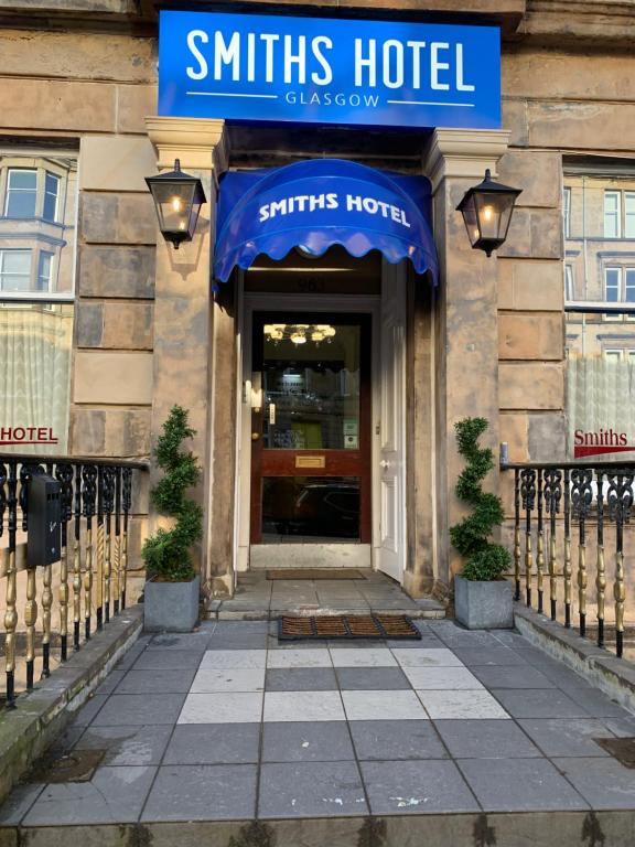 a hotel entrance with a blue awning on a building at Smiths Hotel in Glasgow