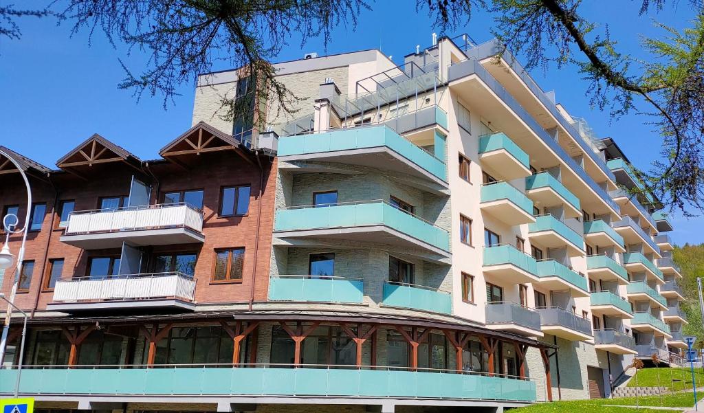 an image of a building with balconies at Apartament DOMINO Krynica Zdrój in Krynica Zdrój