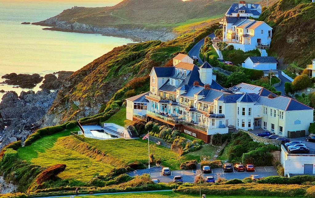 
a house on a hill overlooking the ocean at Watersmeet Hotel in Woolacombe
