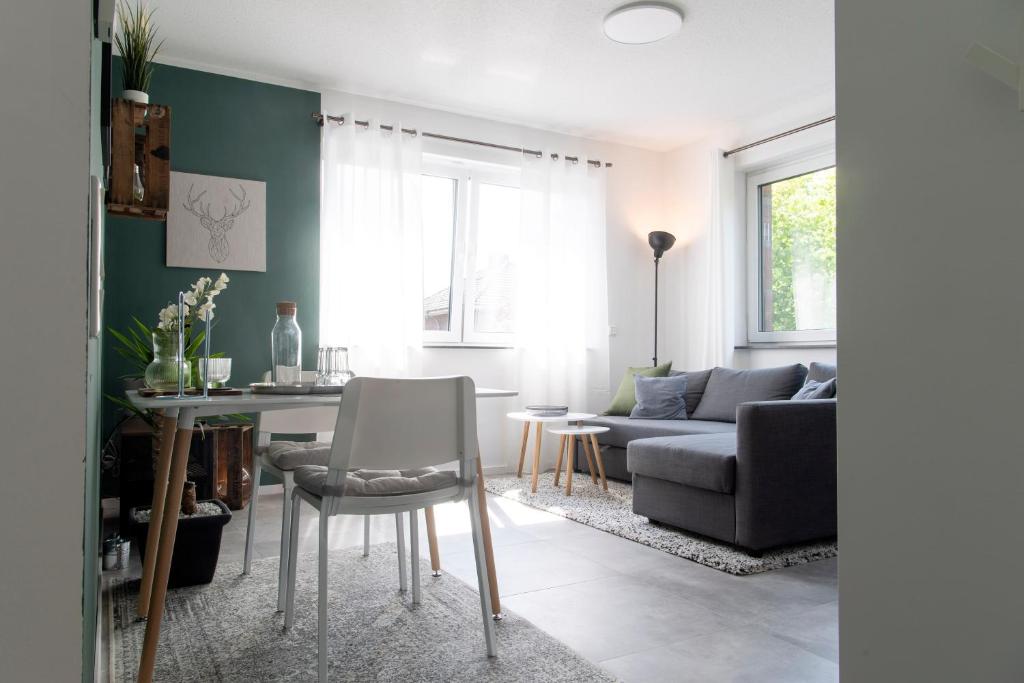 uma sala de estar com uma mesa e um sofá em ☆ Stylisches Apartment in Gronau ☆ Direkt am St. Antonius-Hospital ☆ zentral gelegen em Gronau