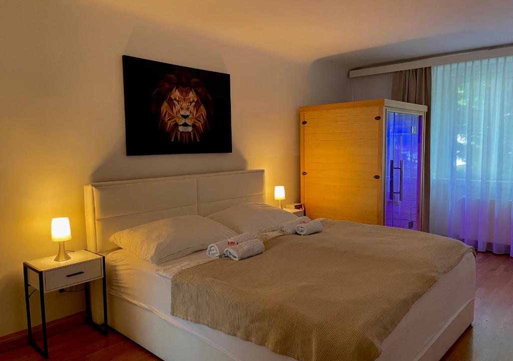 a bedroom with a bed with a lion picture on the wall at Apartment Wien Mitte in Vienna